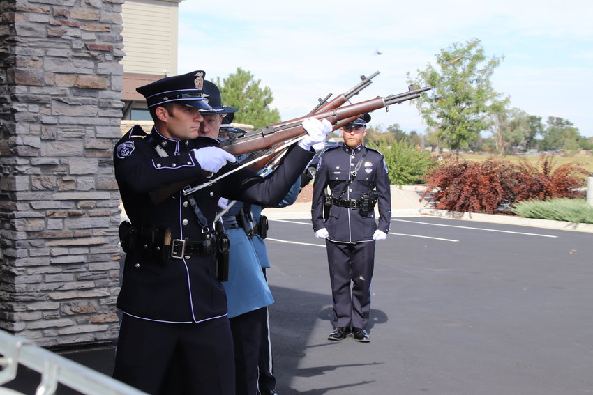 Officers from Adams County and Brighton fire a salute for Brighton police Cmdr. Frank Acosta at close of his Sept. 29 funeral at Orchard Church in Henderson.